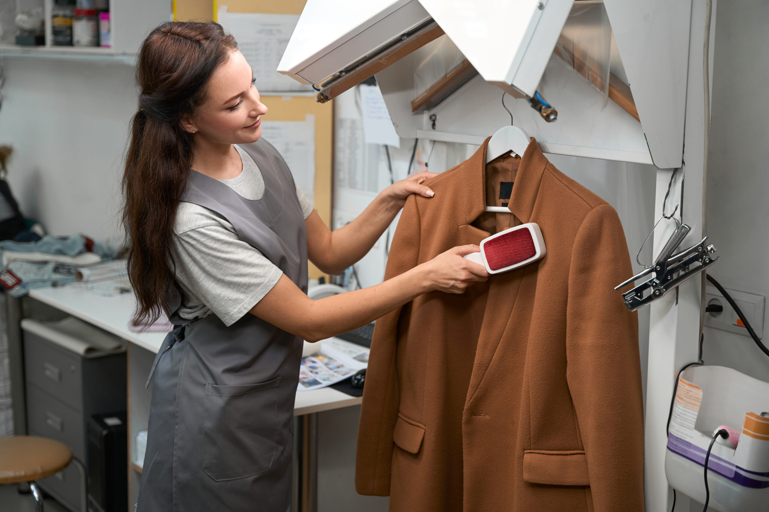 Professional suit dry cleaning service in London, showcasing a clean and neatly pressed suit hanging on a rack inside a modern dry cleaning shop